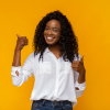 blakc woman cheering happy with yellow background